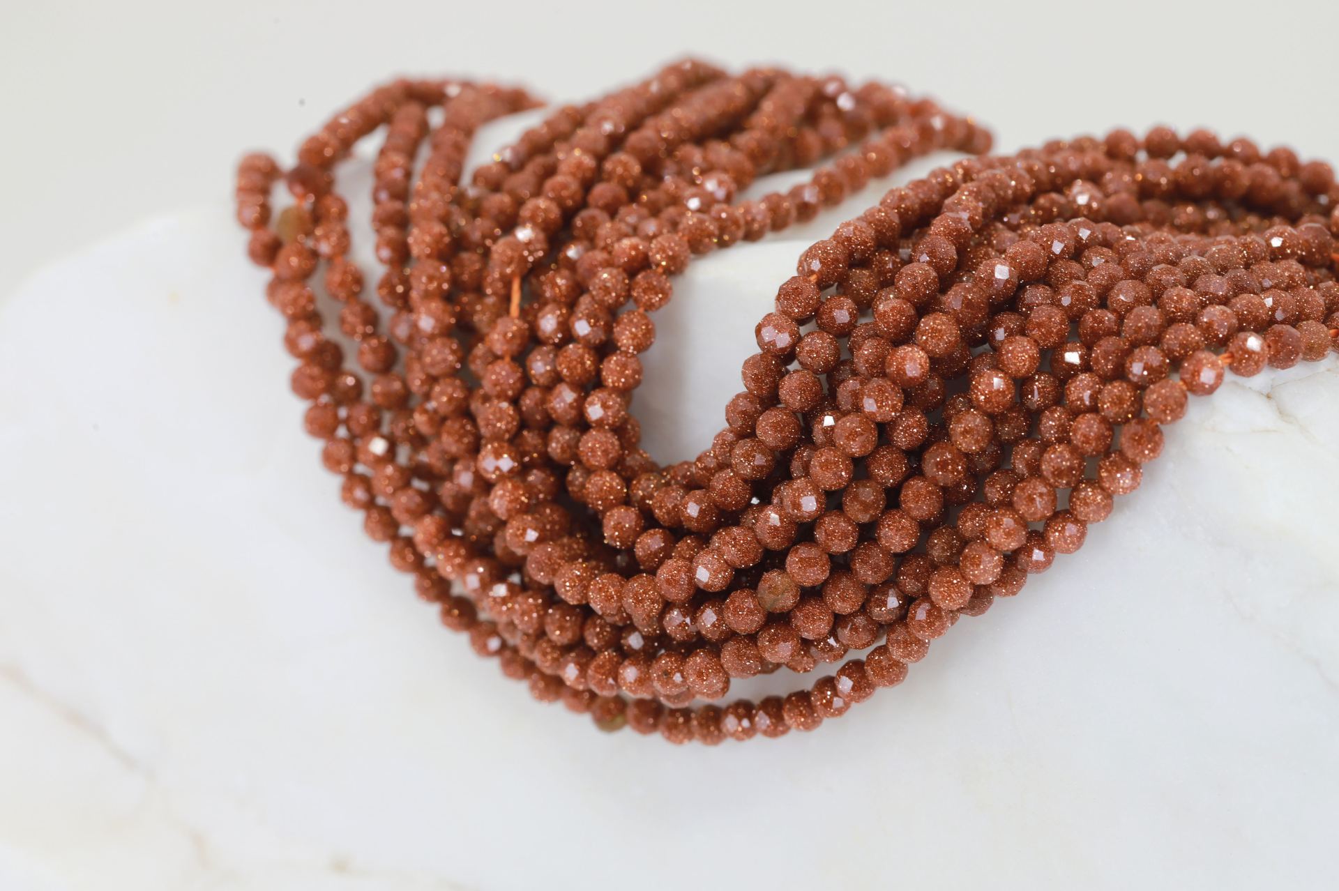 3mm-round-faceted-goldstone-brown