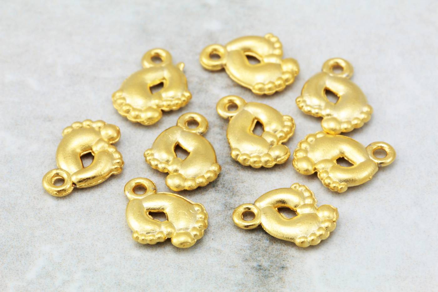 gold-plated-metal-footprint-pendant-char